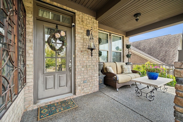 view of exterior entry with a porch