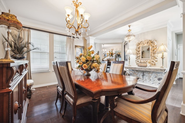 dining room featuring decorative columns, dark wood-type flooring, crown molding, and a chandelier