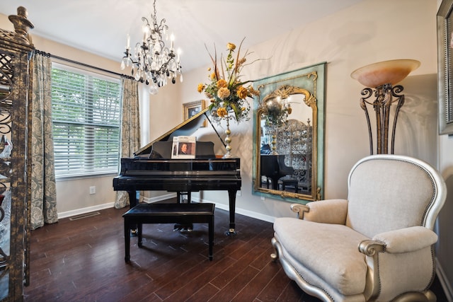 sitting room featuring wood-type flooring and a chandelier