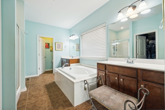 bathroom with tile patterned floors, vanity, and separate shower and tub