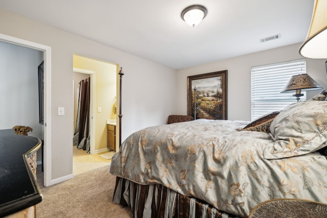 carpeted bedroom featuring ensuite bath