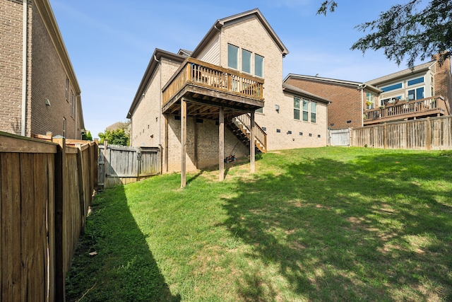 back of house featuring a deck and a yard