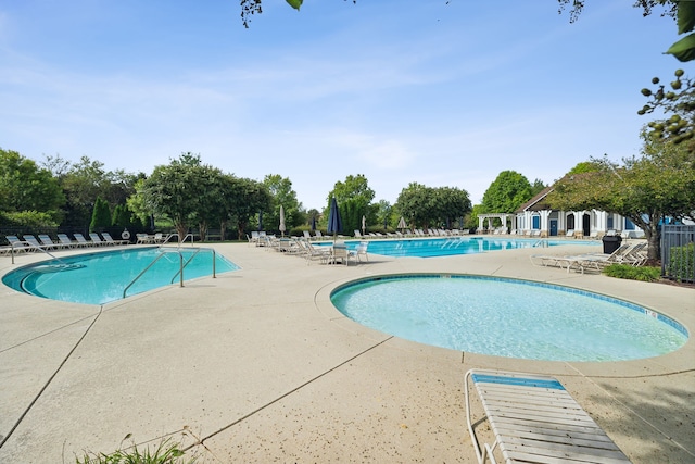 view of swimming pool featuring a patio area