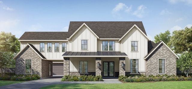 view of front of property with a front yard, french doors, and a garage