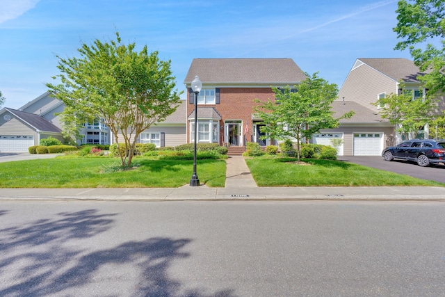 colonial-style house featuring a front lawn and a garage