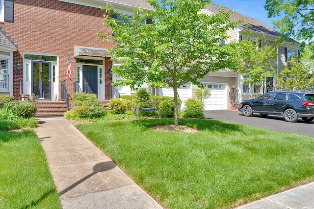 view of front of property with a garage and a front lawn