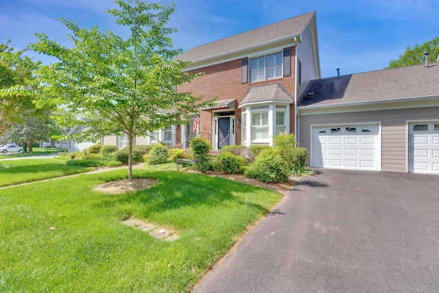 view of front of property featuring a front yard and a garage