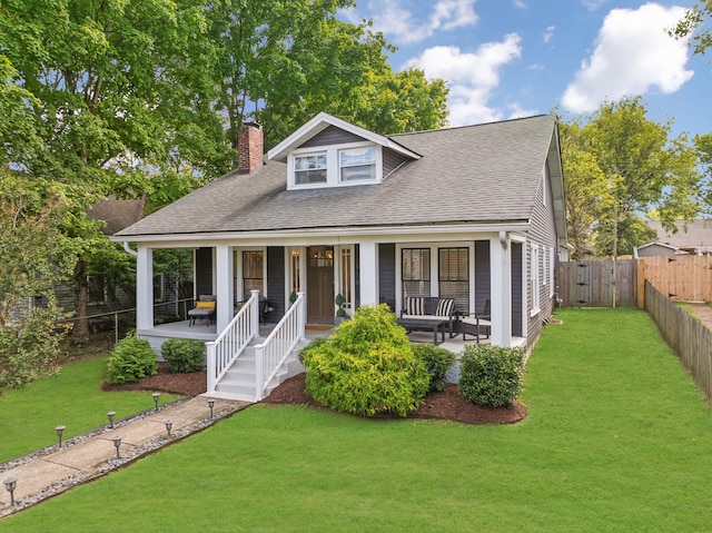 view of front facade featuring covered porch and a front yard