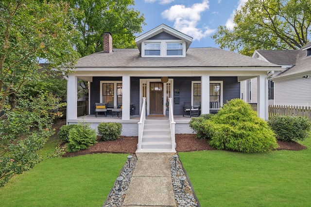 bungalow-style house with a front lawn and a porch