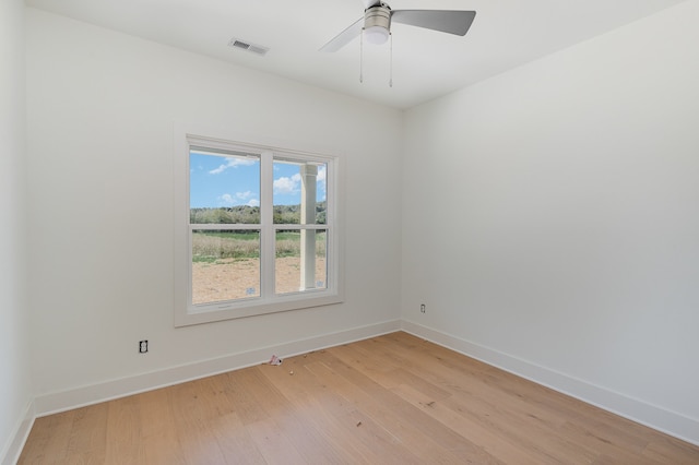 empty room with ceiling fan and light wood-type flooring