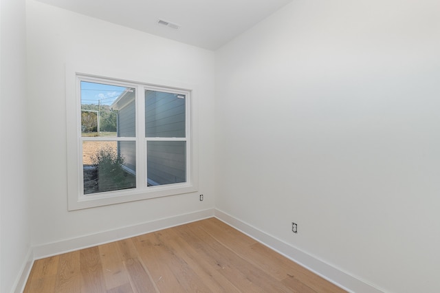 spare room with wood-type flooring