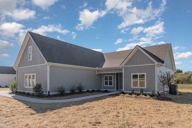 view of front of property with central AC unit and a front yard