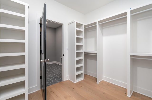 walk in closet featuring hardwood / wood-style floors