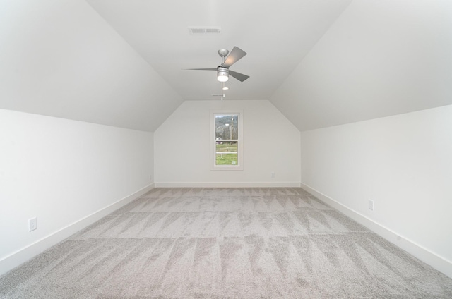 bonus room featuring light colored carpet, vaulted ceiling, and ceiling fan