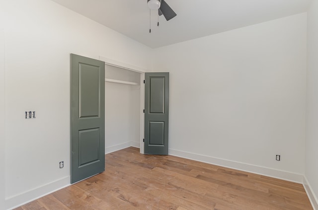 unfurnished bedroom with light wood-type flooring, a closet, and ceiling fan