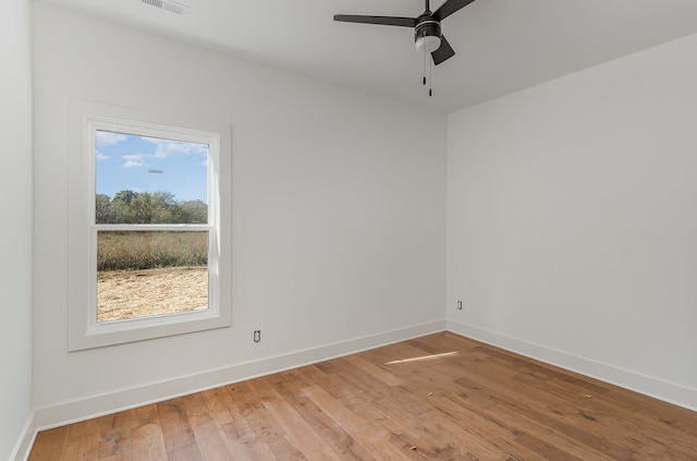 empty room featuring ceiling fan and hardwood / wood-style flooring