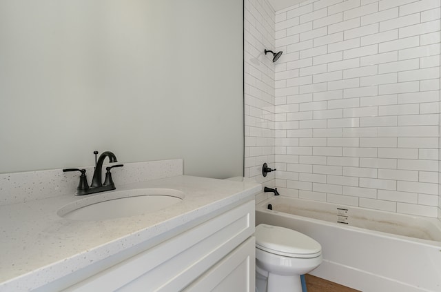 full bathroom featuring vanity, tiled shower / bath combo, and toilet