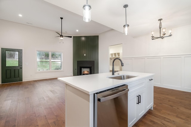 kitchen with dishwasher, sink, decorative light fixtures, a kitchen island with sink, and white cabinets