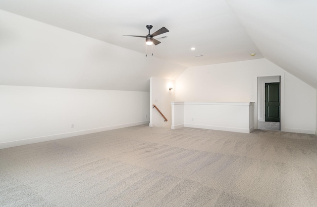 bonus room with ceiling fan, lofted ceiling, and light carpet