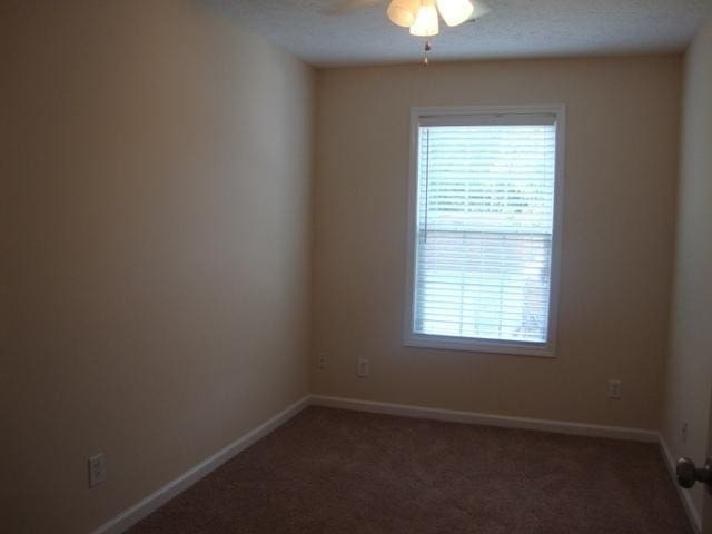 carpeted empty room featuring ceiling fan