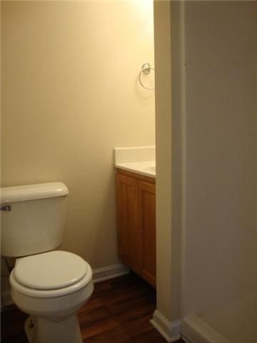 bathroom featuring vanity, hardwood / wood-style floors, and toilet