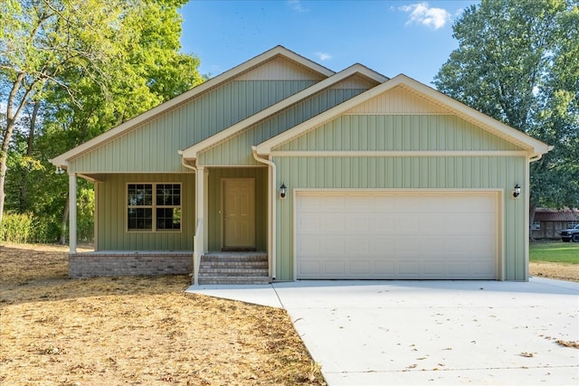 craftsman inspired home with a garage and covered porch