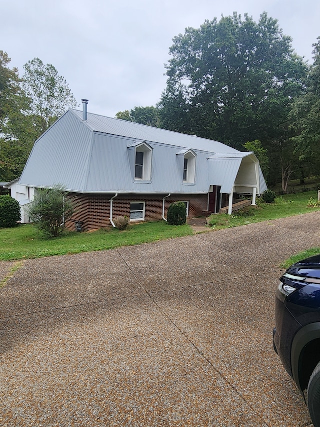 view of front of house with a front yard and a carport