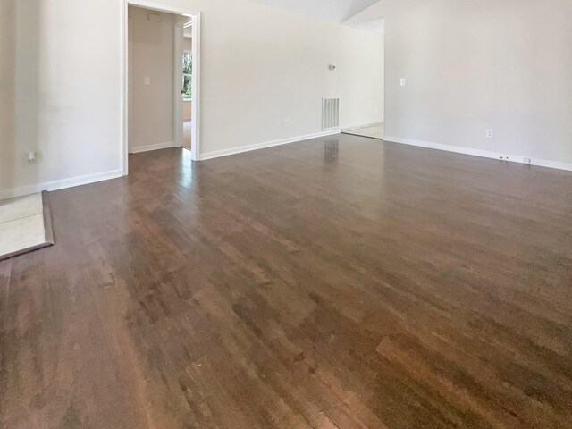 empty room featuring dark wood-type flooring