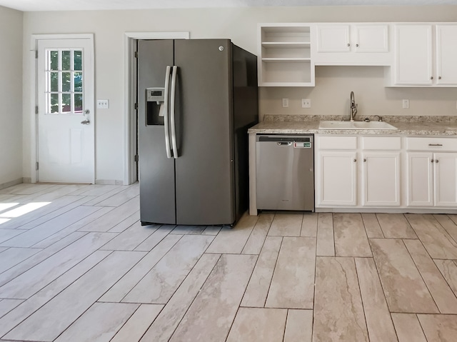 kitchen featuring light hardwood / wood-style flooring, stainless steel appliances, white cabinetry, and sink