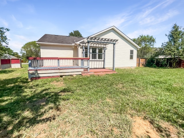 rear view of house with a pergola, a yard, and a wooden deck