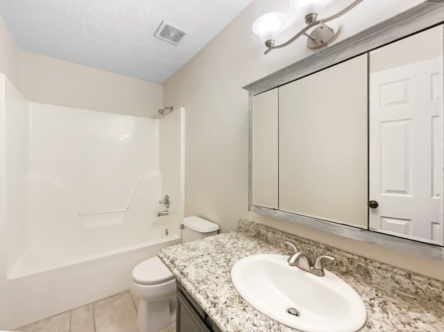 full bathroom featuring vanity, a textured ceiling, tile patterned flooring, toilet, and bathtub / shower combination