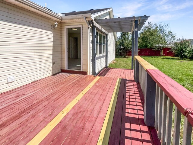 deck with a pergola and a lawn