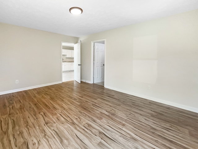 unfurnished room with wood-type flooring