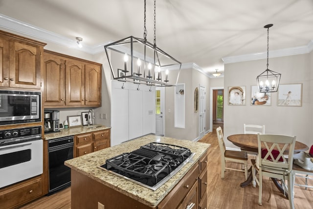 kitchen featuring stainless steel microwave, white oven, a center island, and light hardwood / wood-style flooring