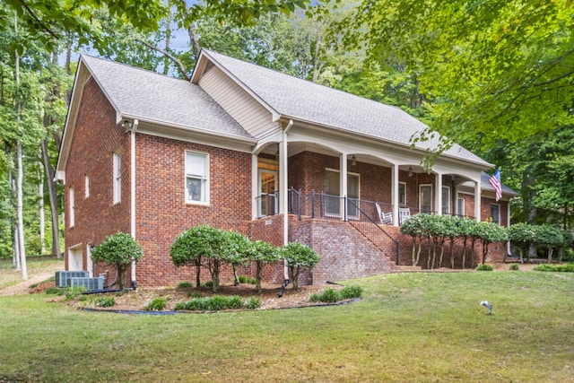 view of front of house with a front lawn, central AC unit, and a porch