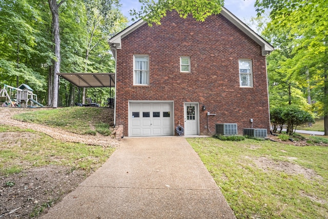 view of home's exterior with central AC, a yard, and a garage