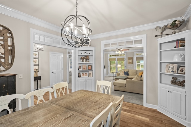 dining room featuring ceiling fan with notable chandelier, ornamental molding, and light hardwood / wood-style flooring