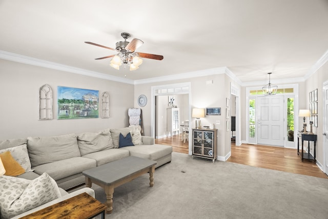 living room with wood-type flooring, ceiling fan, and crown molding