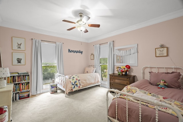 bedroom with ceiling fan, crown molding, and carpet