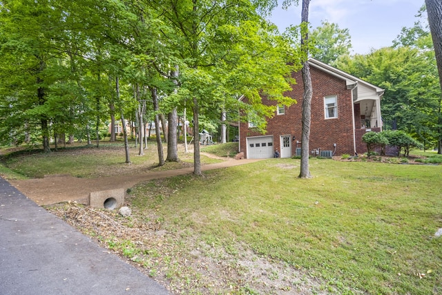 exterior space featuring a garage and central AC