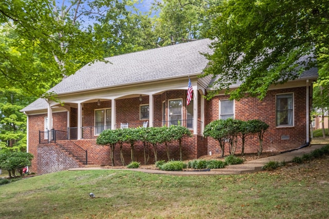 view of front of home with covered porch and a front yard