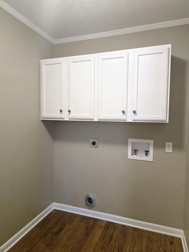 laundry room with washer hookup, dark hardwood / wood-style flooring, crown molding, electric dryer hookup, and cabinets