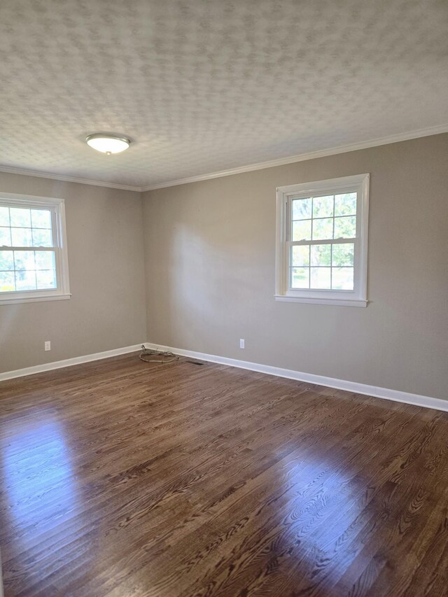 unfurnished room featuring a textured ceiling, crown molding, and dark hardwood / wood-style flooring