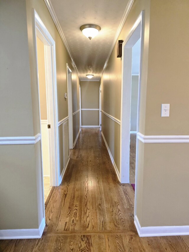 hall featuring crown molding and hardwood / wood-style floors