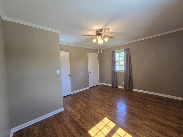 spare room with ornamental molding, ceiling fan, and dark hardwood / wood-style floors