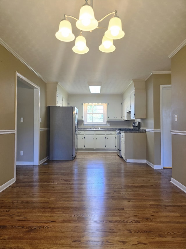 kitchen featuring white cabinets, appliances with stainless steel finishes, dark hardwood / wood-style floors, and ornamental molding