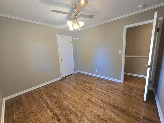 unfurnished bedroom with ceiling fan, ornamental molding, and hardwood / wood-style floors