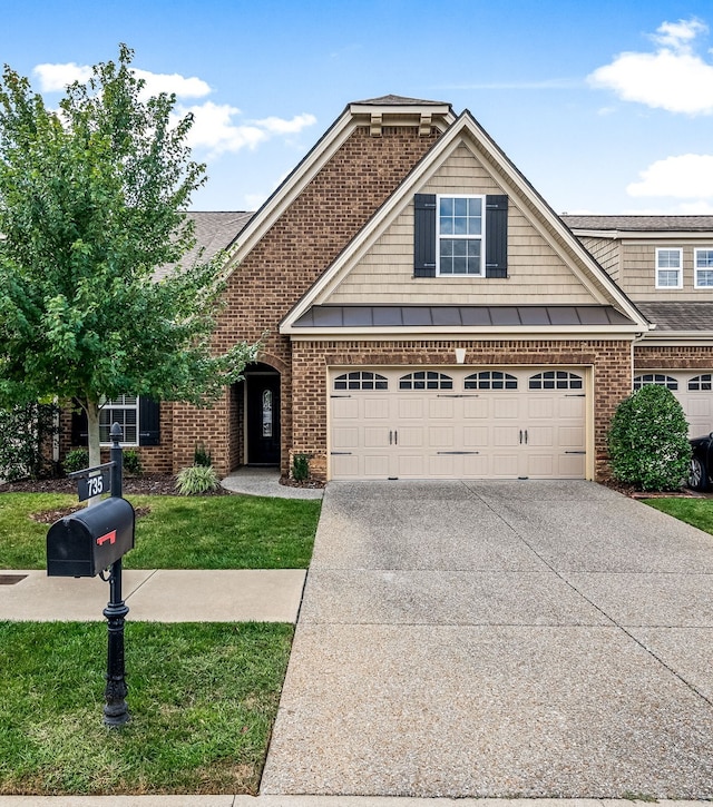 view of front of house with a front yard and a garage