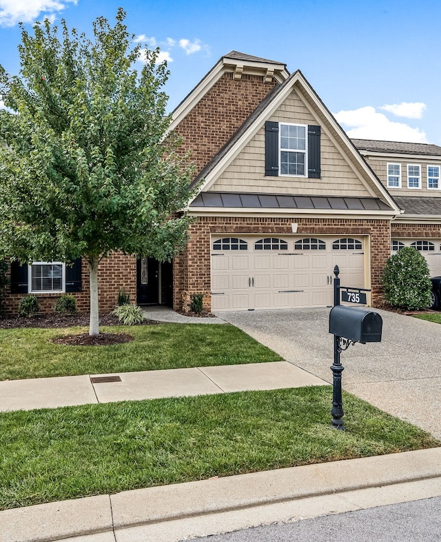 view of front of home featuring a garage and a front lawn