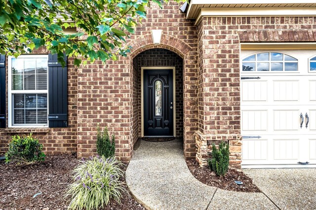 doorway to property with a garage